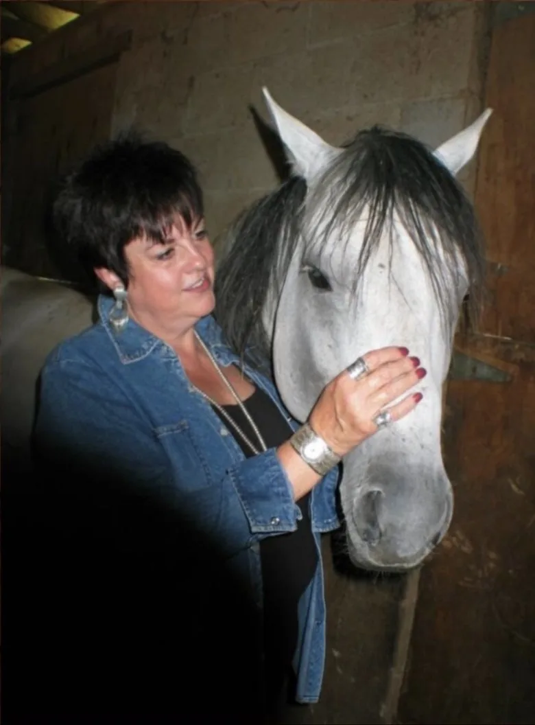 Karen's healing work, hands on a grey horse